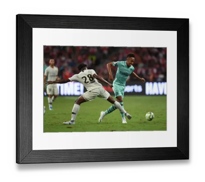 Framed Print : Arsenal Stars Clash: Aubameyang vs. Mbe Soh in Arsenal vs. PSG Showdown