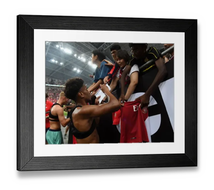 Framed Print : Reiss Nelson Greets Fans: Arsenal's Star Player Connects with Supporters after Arsenal vs. Paris Saint-Germain in Singapore (2018)
