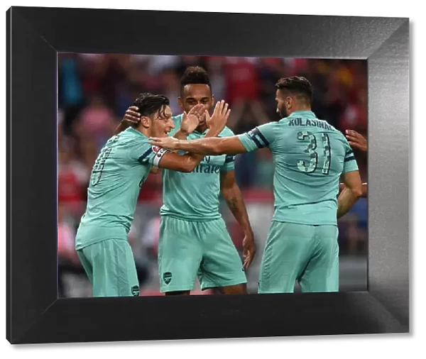 Arsenal's Ozil and Kolasinac Celebrate Goal Against Paris Saint-Germain, 2018