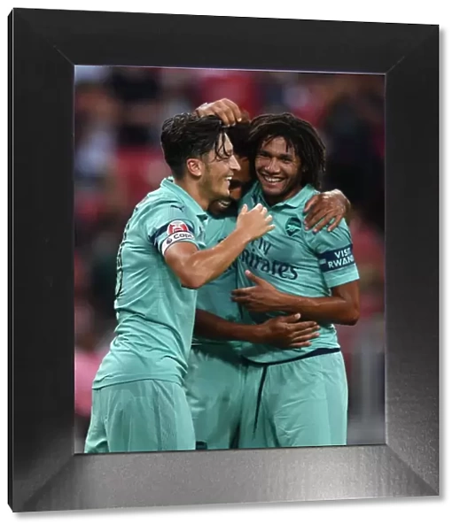 Arsenal's Ozil and Elneny: Celebrating a Goal Against Paris Saint-Germain in the 2018 Pre-Season Friendly