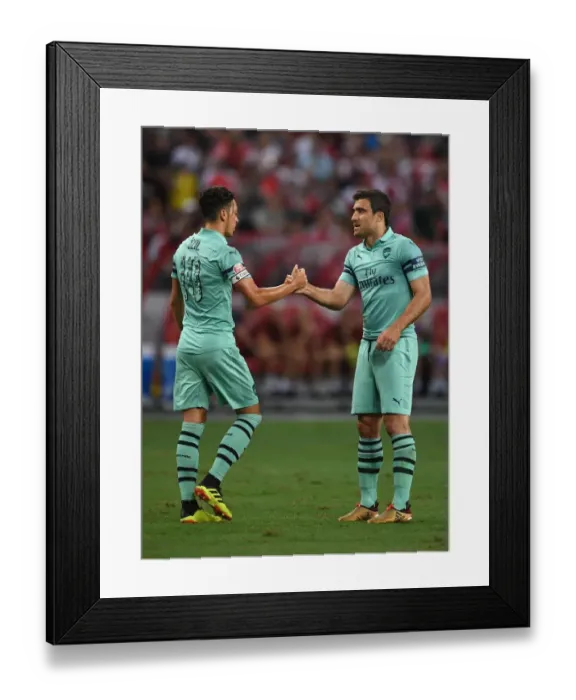 Framed Print : Arsenal's Ozil and Sokratis: Unity in Victory - Celebrating a Goal Against Paris Saint-Germain in the 2018 International Champions Cup (Singapore) Framed Print : Arsenal's Ozil and Sokratis: Unity in Victory - Celebrating a Goal Against Paris Saint-Germain in the 2018 International Champions Cup (Singapore)