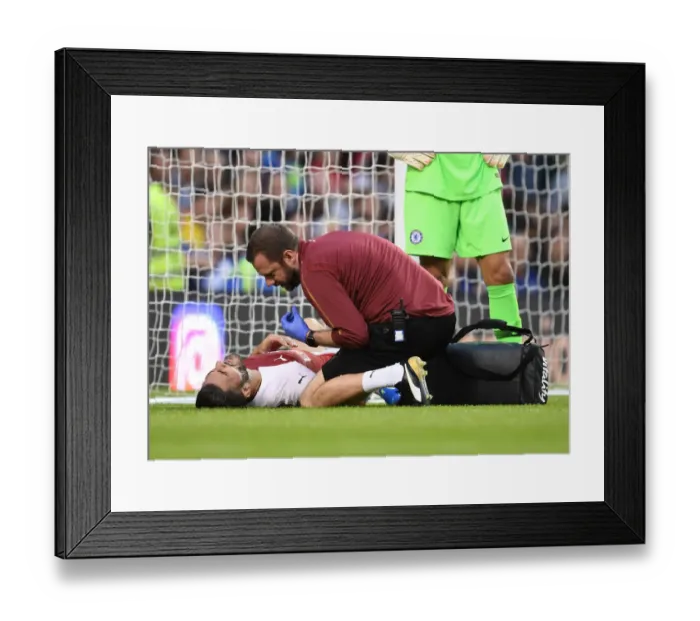 Framed Print : Arsenal's Chris Morgan Tends to Injured Sead Kolasinac during Arsenal v Chelsea Pre-Season Friendly (2018-19)