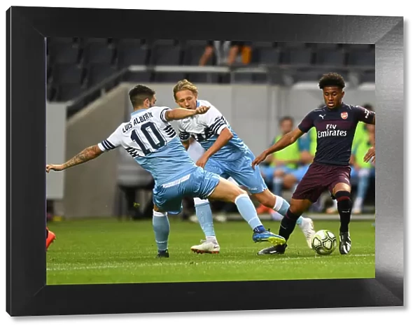 Arsenal's Reiss Nelson Clashes with Luis Alberto and Lucas Leiva of Lazio during Pre-Season Friendly in Stockholm
