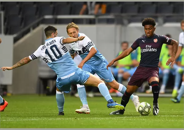 Arsenal's Reiss Nelson Clashes with Luis Alberto and Lucas Leiva of Lazio during Pre-Season Friendly in Stockholm