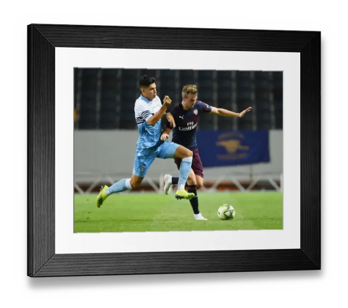 Framed Print : Arsenal's Rob Holding Outmaneuvers Joaquim Correa in Arsenal v SS Lazio Pre-Season Clash