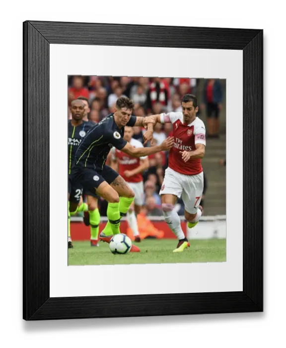 Framed Print : Arsenal's Mkhitaryan Clashes with Manchester City's Stones in Premier League Showdown Framed Print : Arsenal's Mkhitaryan Clashes with Manchester City's Stones in Premier League Showdown