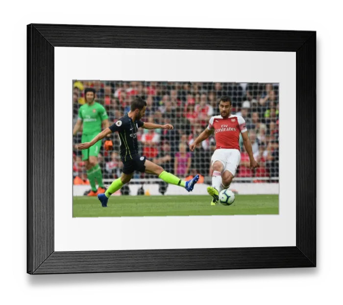 Framed Print : Sokratis under Pressure: Arsenal's Battle Against Manchester City