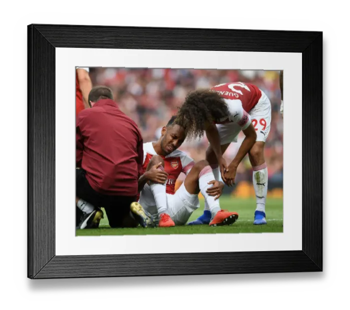 Framed Print : Arsenal's Aubameyang Suffers Injury in Arsenal v West Ham United Premier League Clash Framed Print : Arsenal's Aubameyang Suffers Injury in Arsenal v West Ham United Premier League Clash