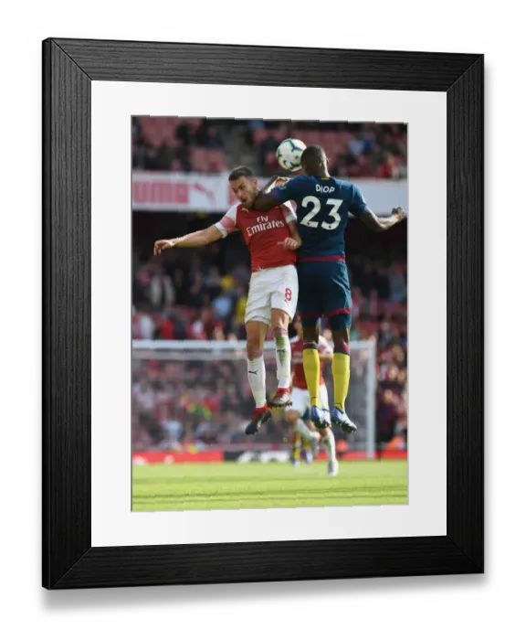 Framed Print : Arsenal's Aaron Ramsey Clashes with West Ham's Issa Diop in Premier League Showdown