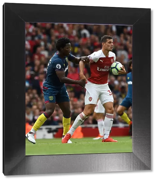 Xhaka vs Sanchez: Intense Clash Between Arsenal's Granit Xhaka and West Ham's Carlos Sanchez in the Premier League