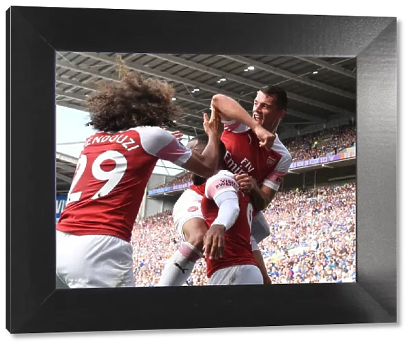 Arsenal's Triumphant Trio: Xhaka, Lacazette, Guendouzi's Jubilant Celebration Against Cardiff City