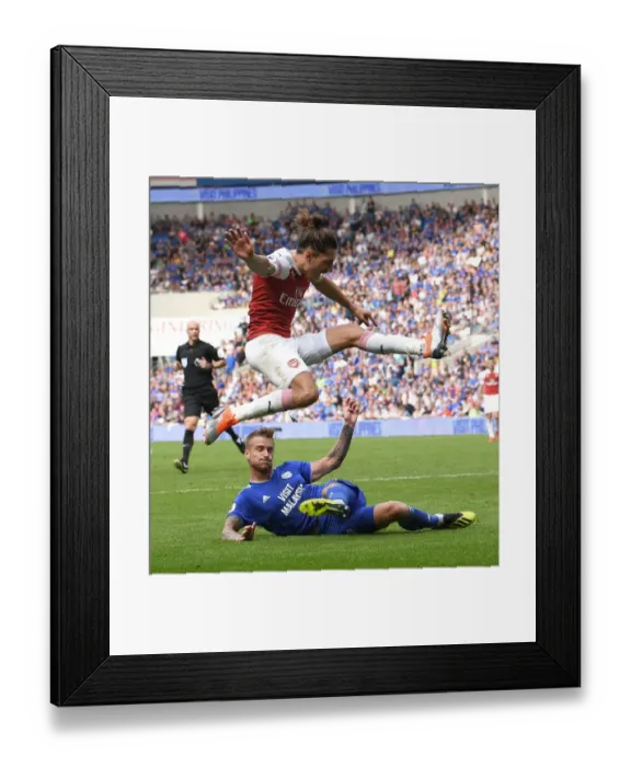 Framed Print : Hector Bellerin Leaps Over Joe Bennett: Intense Moment from Cardiff City vs Arsenal FC, Premier League 2018-19