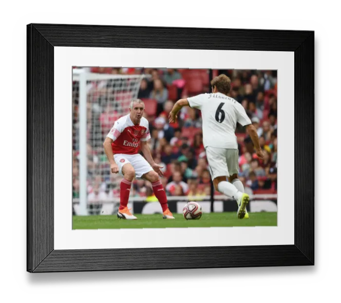 Framed Print : Arsenal Legends vs Real Madrid Legends: Nigel Winterburn vs Julio Llorente - A Football Showdown at Emirates Stadium