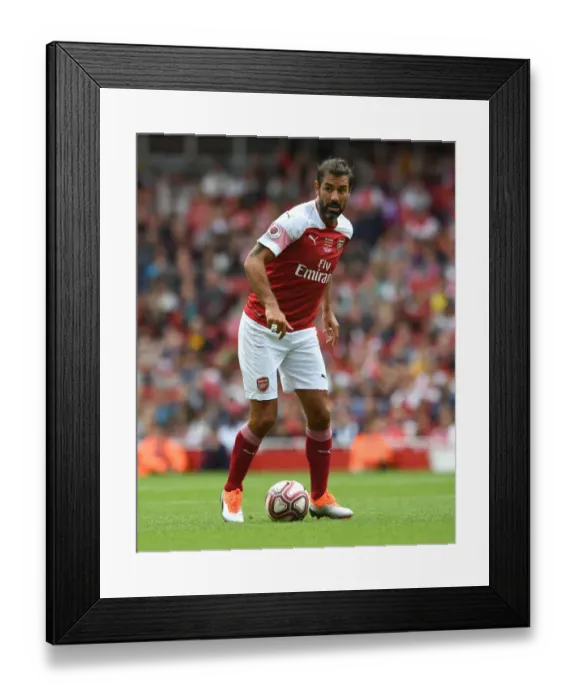 Framed Print : Arsenal Legends vs Real Madrid Legends: A Clash of Football Greats - Robert Pires in Action