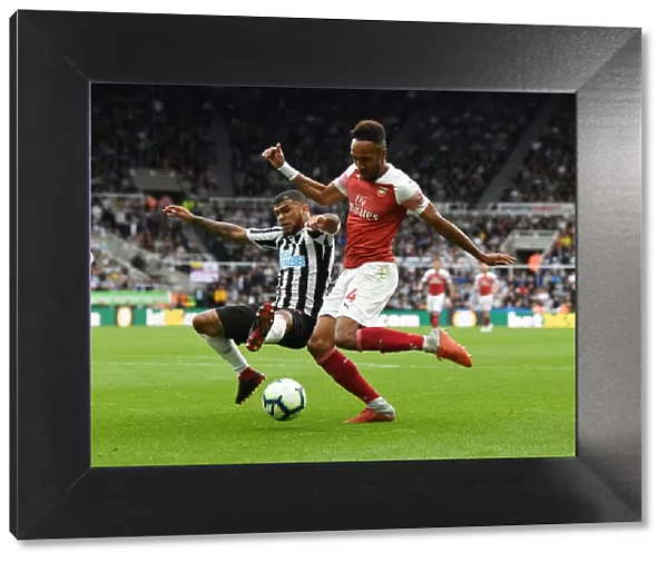 Aubameyang vs Yedlin: A Battle for Ball Possession - Arsenal's Pierre-Emerick Aubameyang Clashes with Newcastle United's DeAndre Yedlin during the Premier League Match
