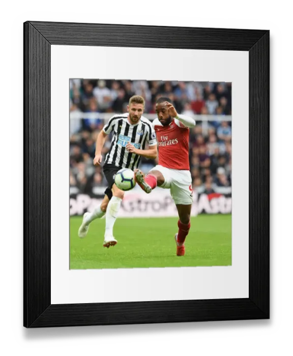 Framed Print : Lacazette vs Dummett: Intense Battle at St. James Park - Newcastle United vs Arsenal FC, Premier League 2018-19