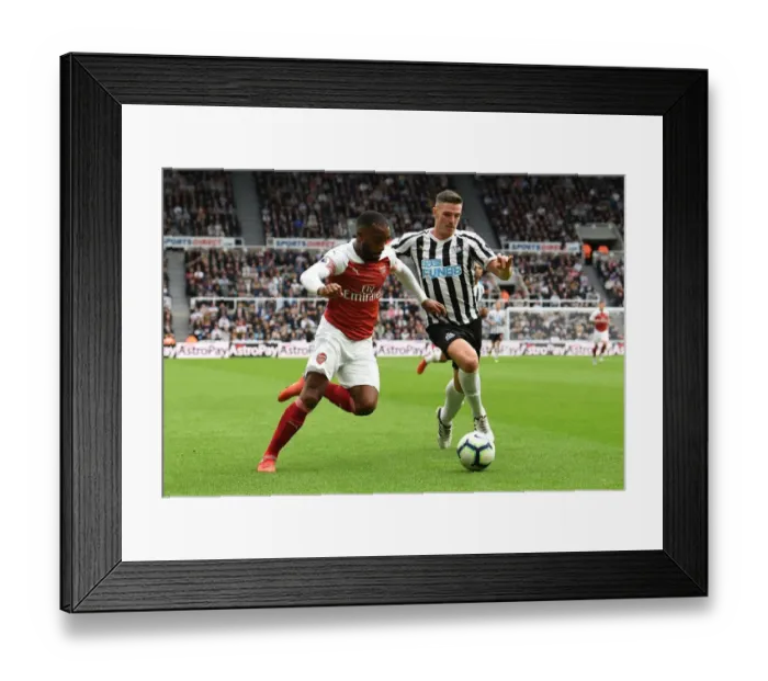 Framed Print : Arsenal's Alexandre Lacazette Faces Off Against Newcastle's Ciaran Clark in Premier League Clash