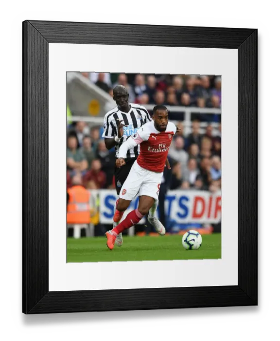 Framed Print : Clash at St. James Park: Lacazette vs Diame in Premier League Showdown Framed Print : Clash at St. James Park: Lacazette vs Diame in Premier League Showdown