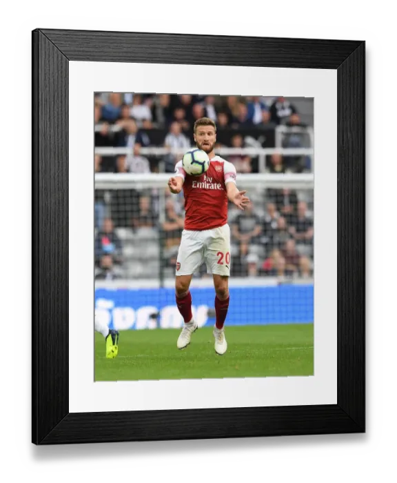 Framed Print : Shkodran Mustafi's Unwavering Concentration in the Heat of Newcastle United vs Arsenal FC Clash (2018-19)