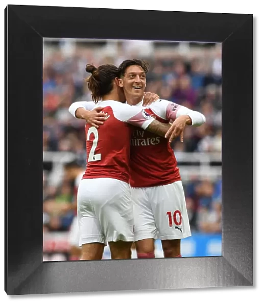 Arsenal's Ozil and Bellerin: A Celebratory Moment after Scoring against Newcastle United