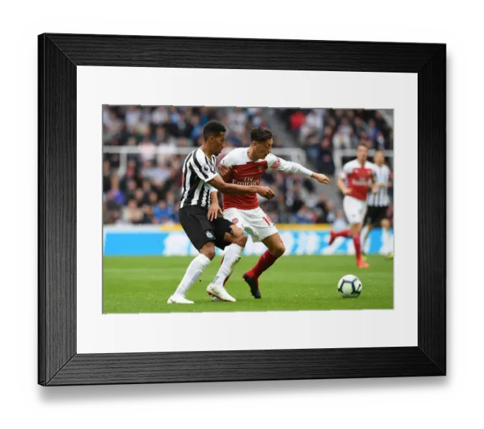 Framed Print : Mesut Ozil vs. Isaac Hayden: Clash at St. James Park - Newcastle United vs. Arsenal FC, Premier League 2018-19