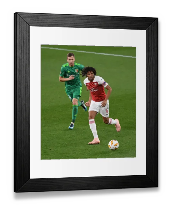 Framed Print : Arsenal's Aubameyang Fends Off Vorskla's Kravchenko in Europa League Clash