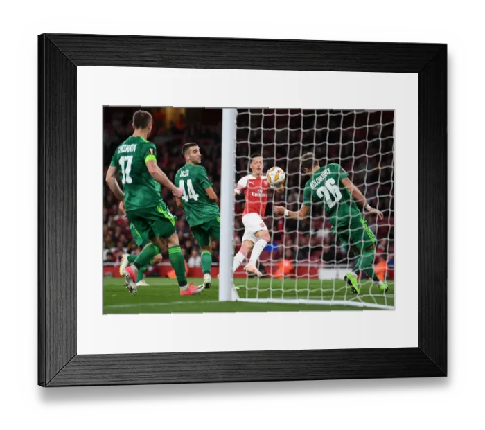 Framed Print : Mesut Ozil Scores Arsenal's Fourth Goal Against Vorskla Poltava in Europa League Match