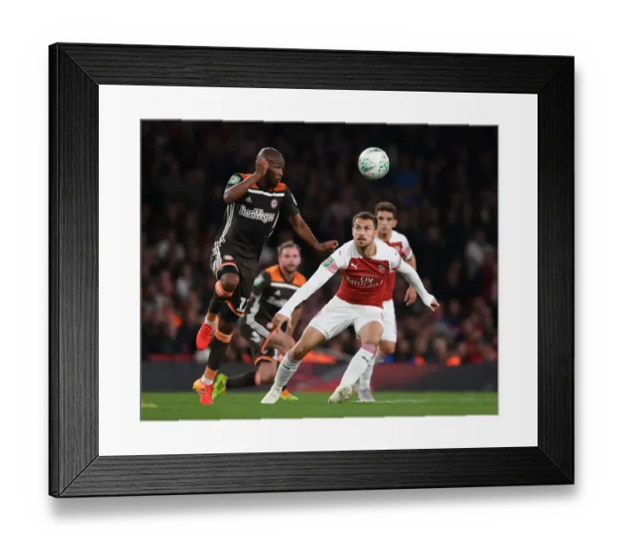Framed Print : Arsenal's Aaron Ramsey vs. Brentford's Kamohelo Mokotjo: A Carabao Cup Showdown Framed Print : Arsenal's Aaron Ramsey vs. Brentford's Kamohelo Mokotjo: A Carabao Cup Showdown
