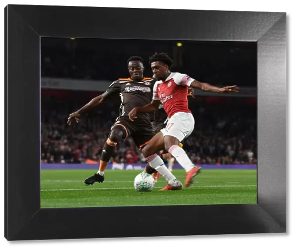 Arsenal's Alex Iwobi Outmaneuvers Brentford's Moses Odubajo in Carabao Cup Clash