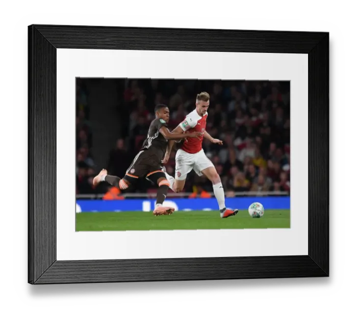 Framed Print : Arsenal's Rob Holding Clashes with Brentford's Ezri Konsa in Carabao Cup Showdown
