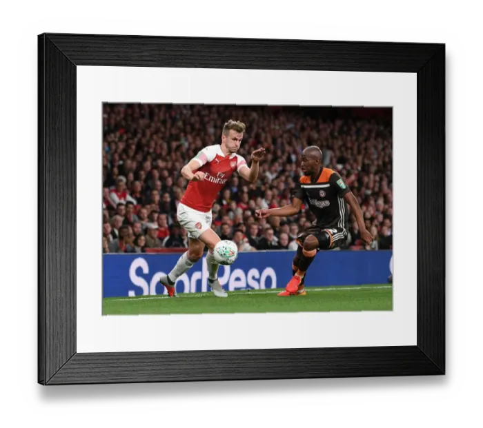 Framed Print : Arsenal's Rob Holding Clashes with Brentford's Moses Odubajo in Carabao Cup Showdown