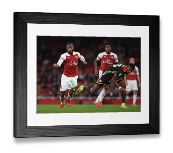 Framed Print : Arsenal's Lacazette Clashes with Brentford's Jeanvier in Carabao Cup Showdown