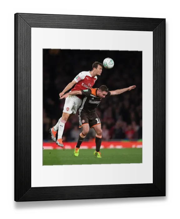 Framed Print : Arsenal's Lichtsteiner Fends Off Judge in Carabao Cup Clash Framed Print : Arsenal's Lichtsteiner Fends Off Judge in Carabao Cup Clash