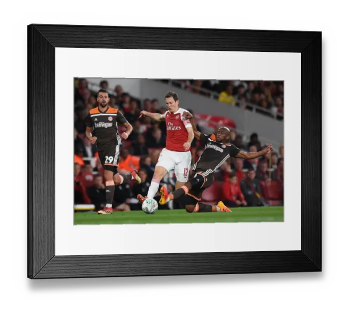 Framed Print : Arsenal's Lichtsteiner vs. Mokotjo: Intense Carabao Cup Showdown