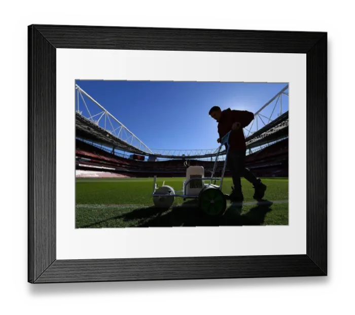 Framed Print : Arsenal Groundsman Meticulously Prepares Impeccable Pitch for Carabao Cup Showdown against Brentford