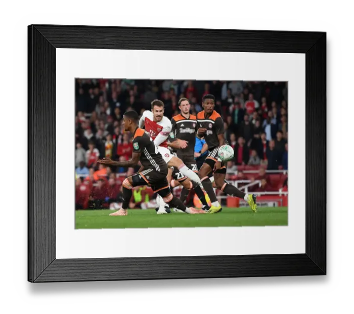Framed Print : Arsenal's Ramsey Faces Off Against Brentford's Jeanvier in Carabao Cup Clash