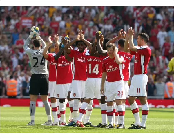 The Arsenal Players clap the fans before the match