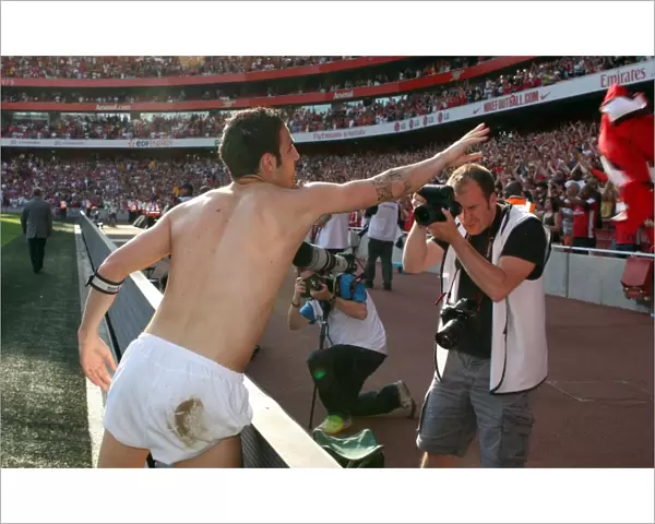 Cesc Fabregas (Arsenal) throws his shrt to the fans after the match