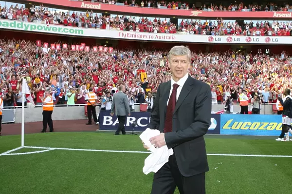 Arsenal manager Arsene Wenger waves to the fans after the match