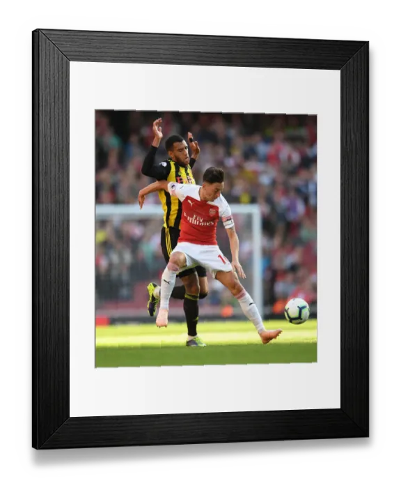 Framed Print : Ozil vs. Capoue: A Premier League Battle at the Emirates Framed Print : Ozil vs. Capoue: A Premier League Battle at the Emirates
