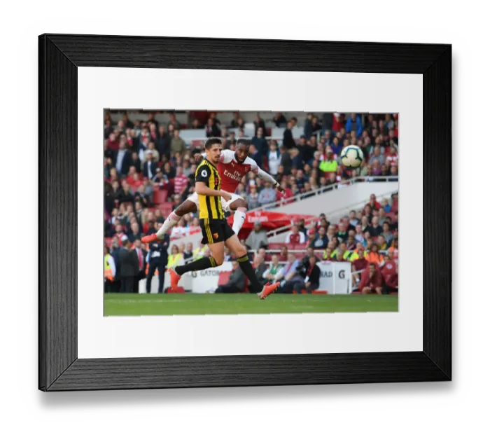 Framed Print : Arsenal's Lacazette Faces Off Against Cathcart in Intense Premier League Clash Framed Print : Arsenal's Lacazette Faces Off Against Cathcart in Intense Premier League Clash