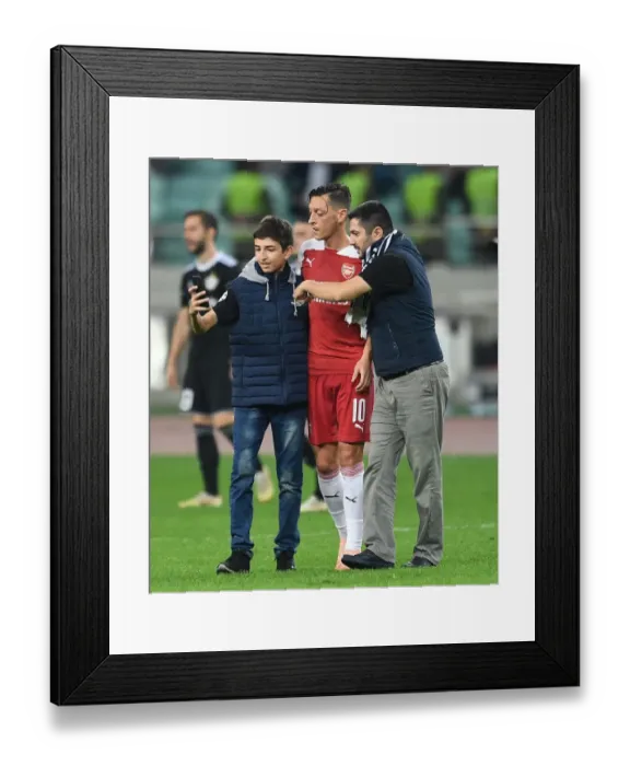 Framed Print : Mesut Ozil Interacts with Fans after Arsenal's UEFA Europa League Match against Qarabag FK