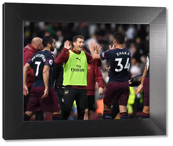 Celebrating Victory: Lichtsteiner and Xhaka Rejoice After Arsenal's Win Against Fulham