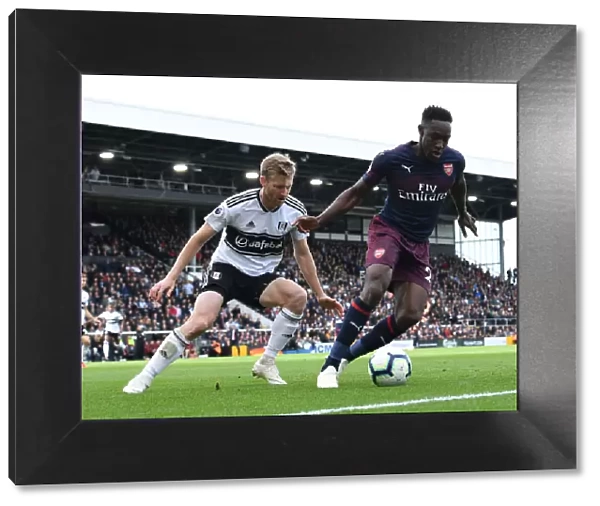 Clash at Craven Cottage: Fulham's Tim Ream Holds Off Arsenal's Danny Welbeck
