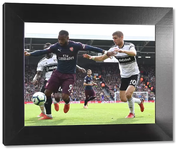 Arsenal's Alexandre Lacazette Clashes with Fulham's Maxime Le Marchand in Premier League Showdown