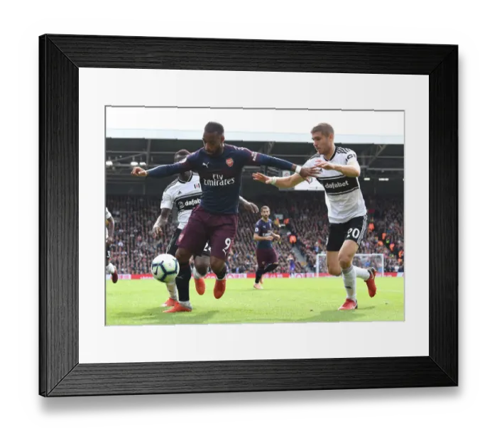 Framed Print : Arsenal's Alexandre Lacazette Clashes with Fulham's Maxime Le Marchand in Premier League Showdown