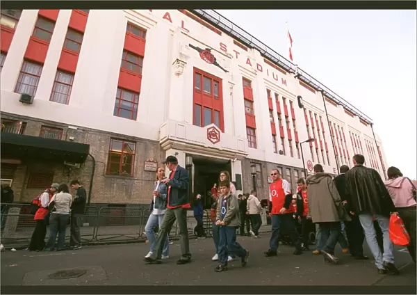 Arsenal fans walk outside the East Stand before the match
