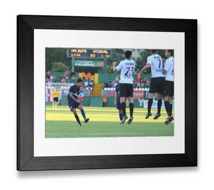 Framed Print : Eduardo shoots past Szombathelyi goalkeeper Rozsa Daniel