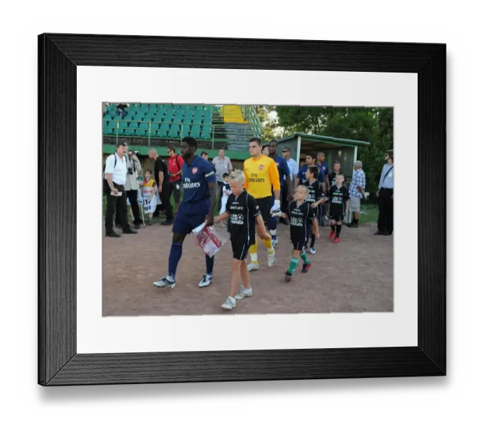 Framed Print : Arsenal captain Kolo Toure leads out the team before the match