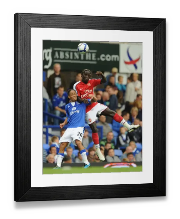 Framed Print : Dominance on the Pitch: Sagna and Pienaar Clash in Arsenal's 6-1 Victory over Everton, 2009